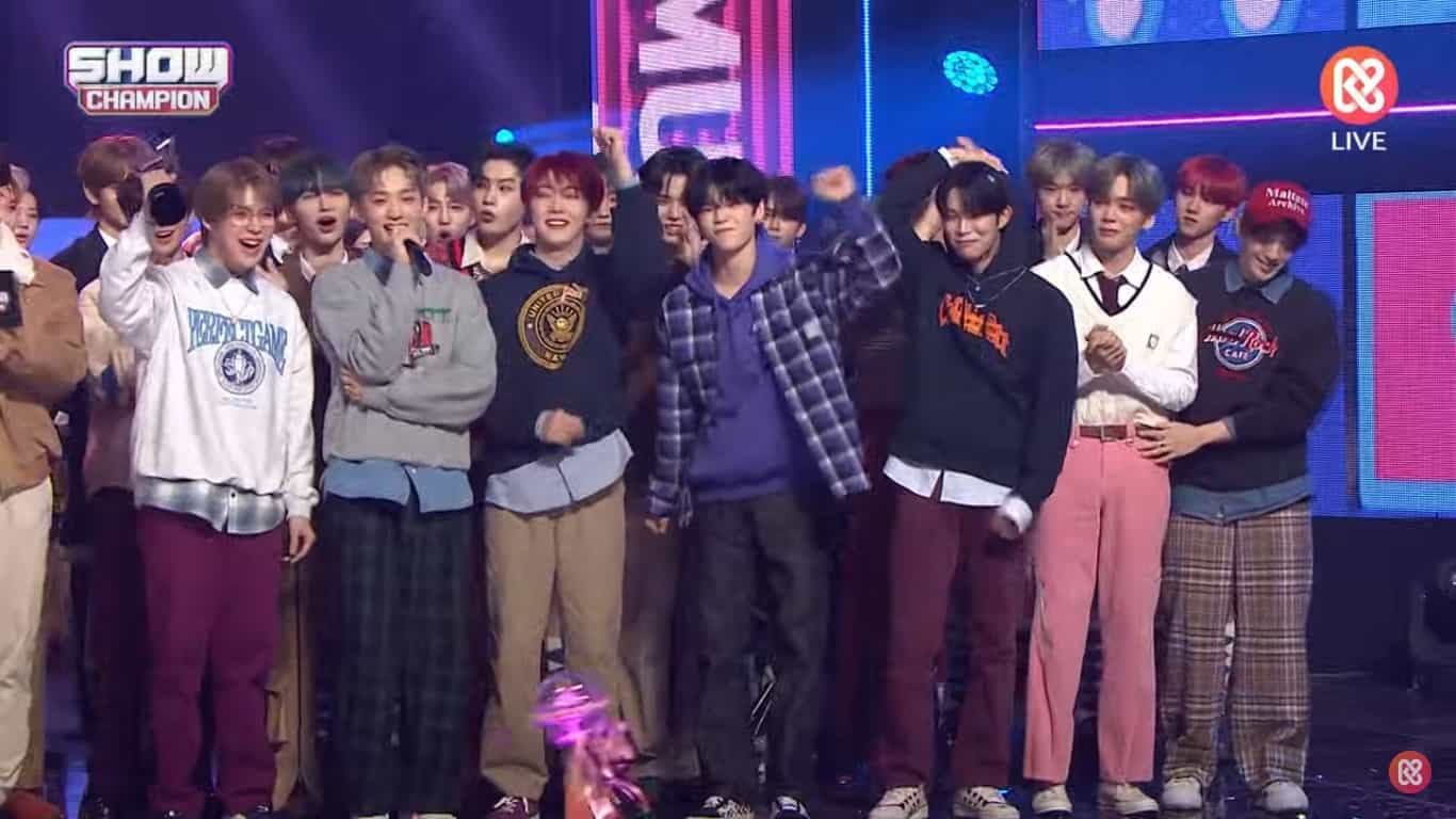 Verivery cheering and holding up their trophy. Some members are in tears.